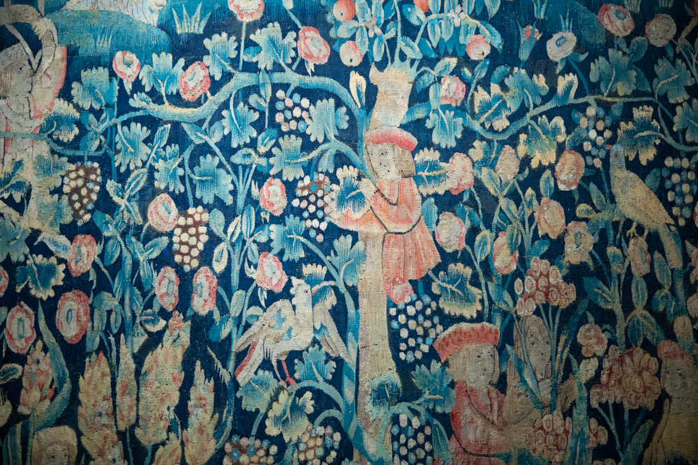 tapestry details tapestry with many characters around vines, fruit trees and flowers - Chateau De Langeais